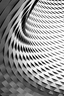 A curved facade covered in white latticework, low angle photography of gray building ceiling HD wallpaper