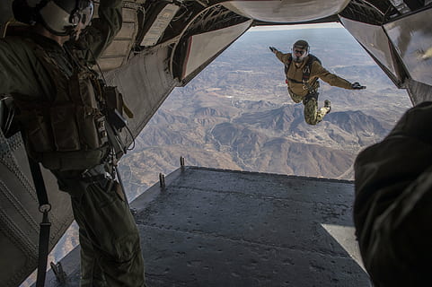 close-up photo of man standing inside plane during daytime HD wallpaper