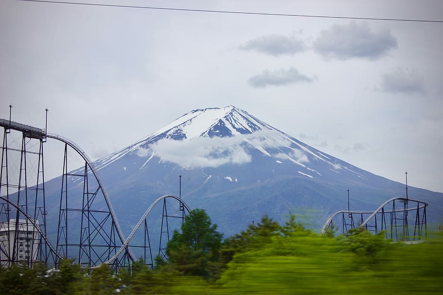 blue mountain under gray sky, roller coaster ride near white mountain HD wallpaper