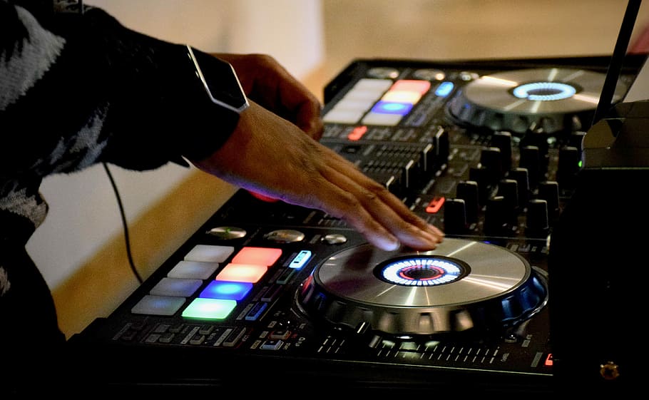 person using DJ turn table, person using black and gray DJ controller HD wallpaper