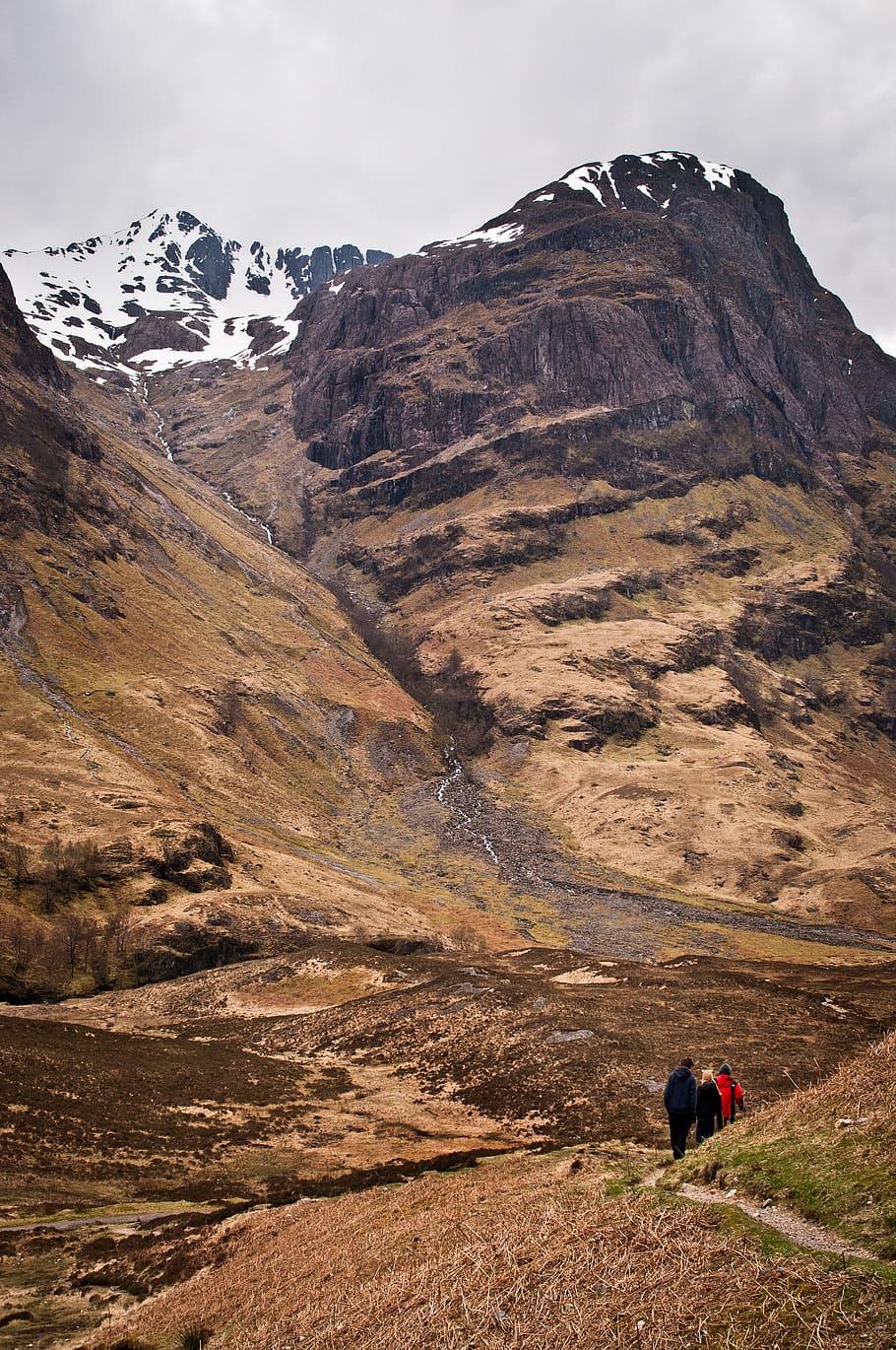 people walking on mountain, three people walking in hill pathway near snow mountain HD wallpaper