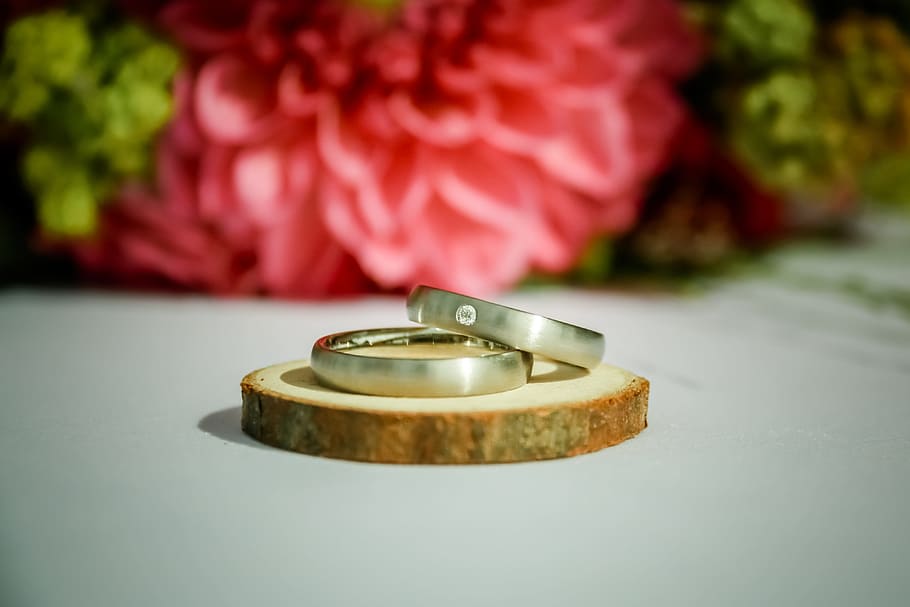 A couple of wedding rings sitting next to a flower photo – Free Image on  Unsplash
