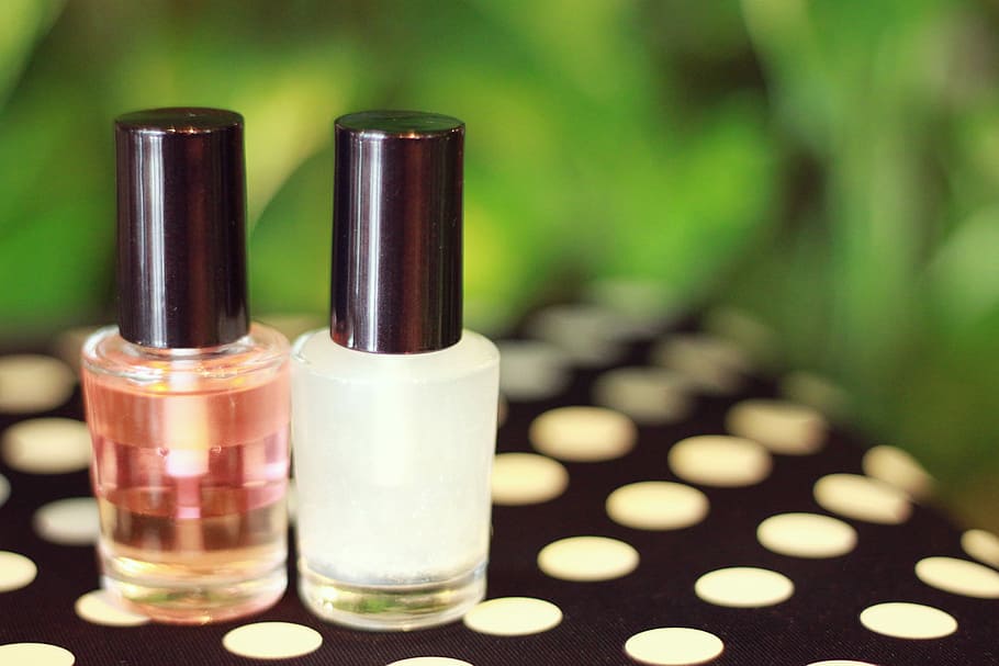 two nail polishes on black and white polka dot surface, beauty Product HD wallpaper