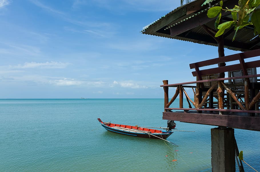 brown and orange boat on body of water, house, travel, building