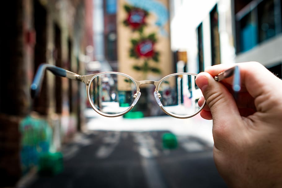 person holding eyeglasses, person holding eyeglasses with silver frames HD wallpaper