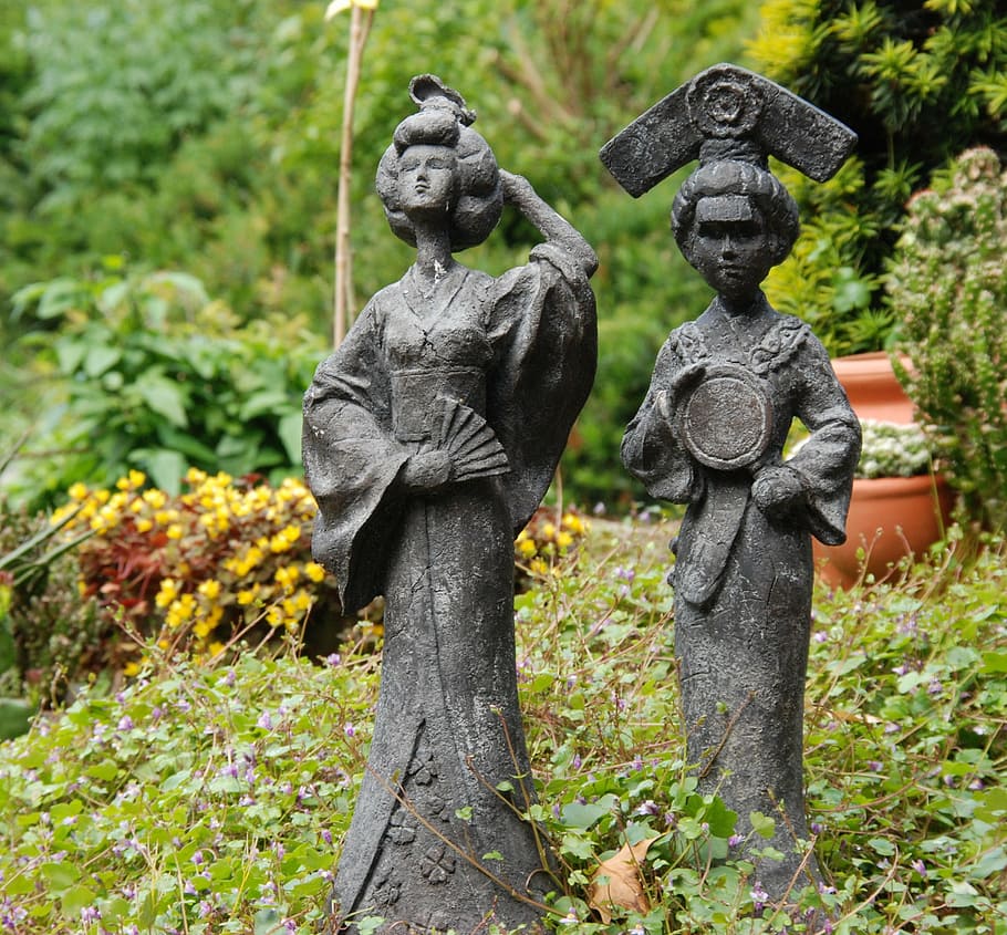 two women concrete statue at the garden near flowers, image HD wallpaper
