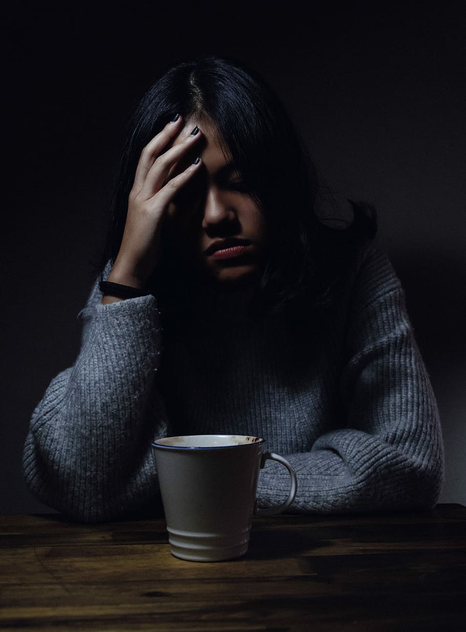 woman in gray sweater seating on chair, woman holding her head white staring on white ceramic cup HD wallpaper