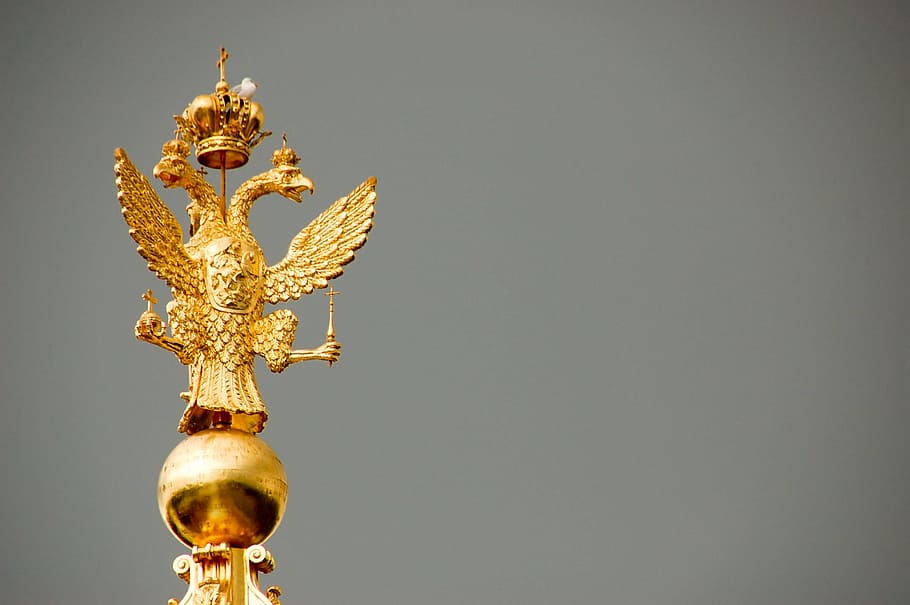 gold-colored bird figurine, architecture, weapons, organ, blue
