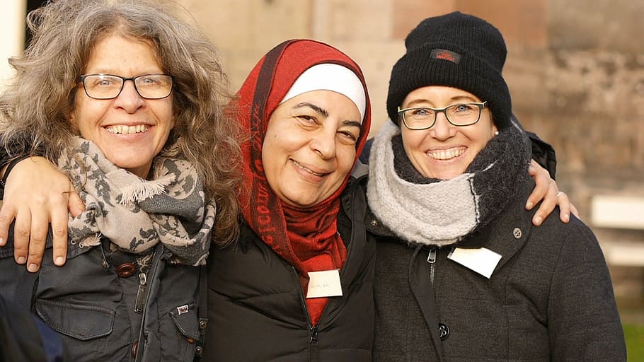 three smiling women in winter tops, refugee, happy, group, cohesion, HD wallpaper
