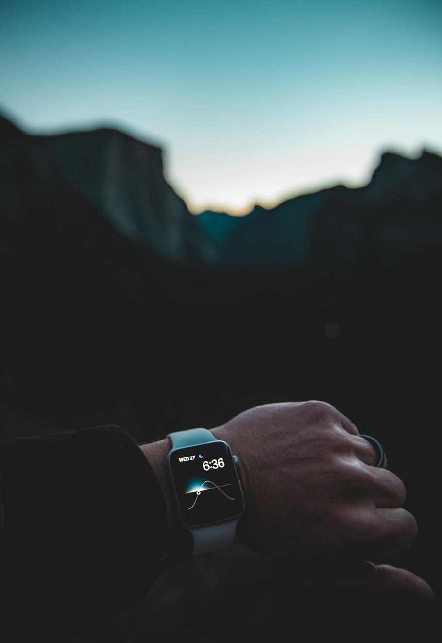silver aluminum case Apple Watch with white Sports band, left person's arm with turned on Apple Watch with white Sport Band in selective focus photography HD wallpaper