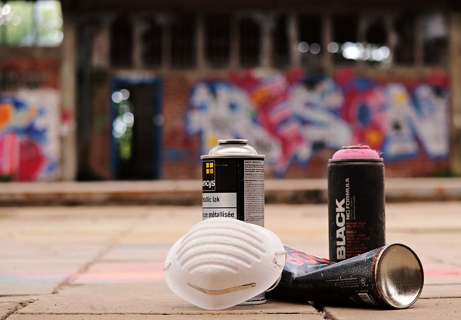selective focus photography of black spray can and white mask HD wallpaper