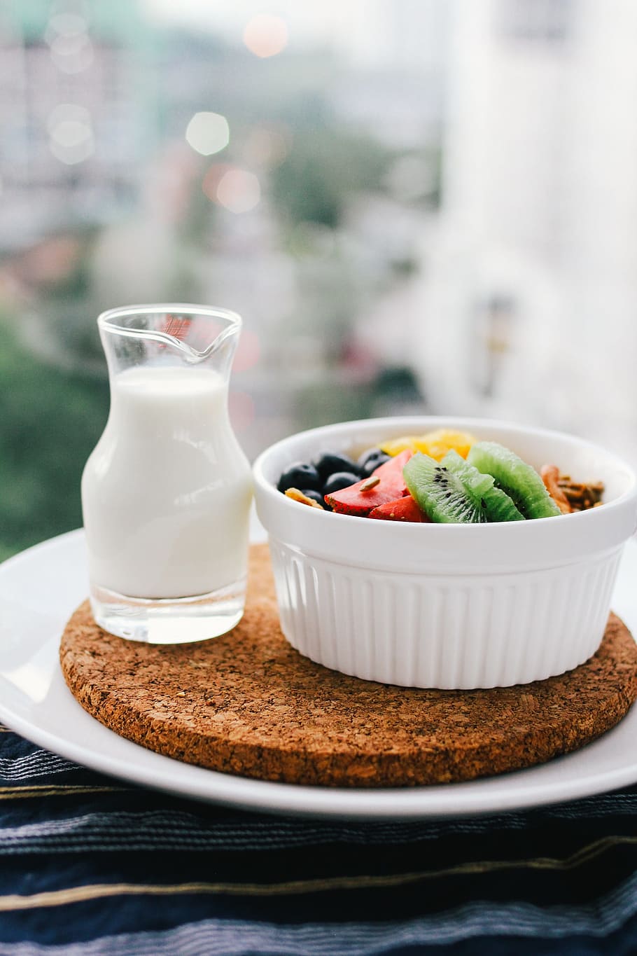 round white ceramic bowl, breakfast, müsli, fruits, milk, muesli