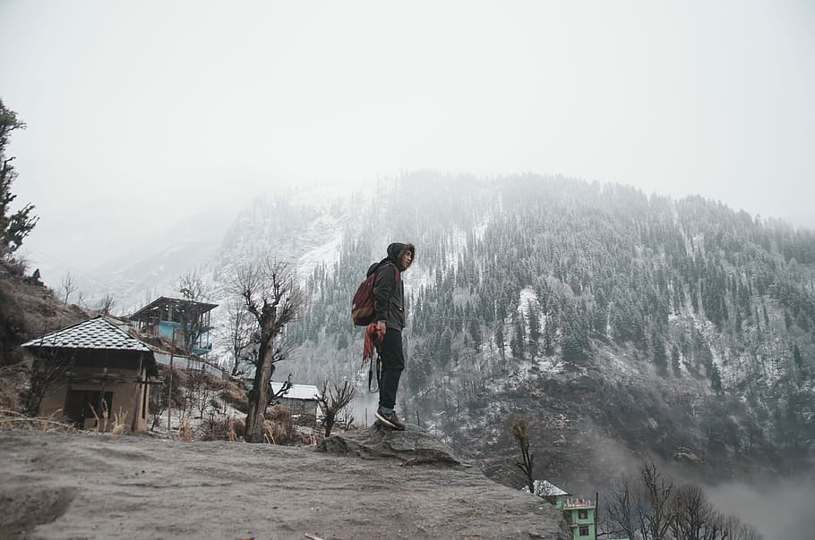 Upward over the mountain, man standing on cliff near house, male HD wallpaper