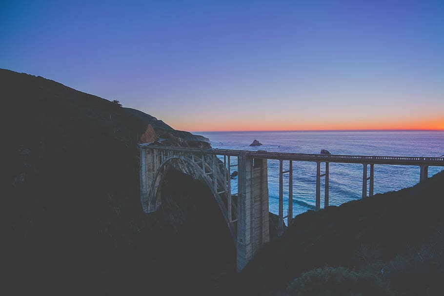 sunset, dusk, bridge, sky, horizon, mountains, cliff, landscape HD wallpaper