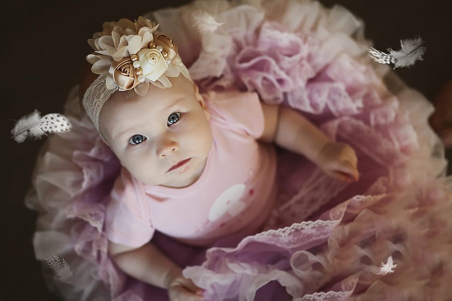 baby in pink tutu dress, girl, ballerina, feathers, portrait