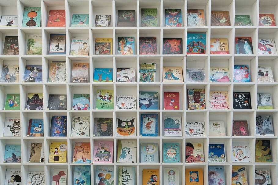 assorted-title books on brown wooden cube organizer, bookcase HD wallpaper