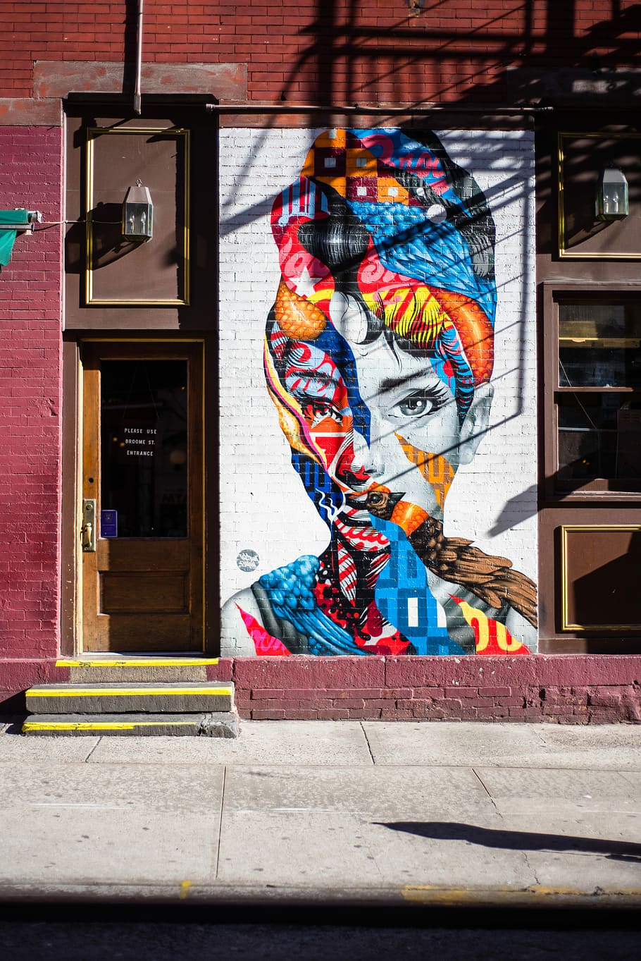 Audrey Hepburn graffiti wall, assorted-color woman face wall art decoration beside half-glass door, HD wallpaper