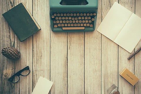 green typewriter beside green hardbound book and book, notebook HD wallpaper
