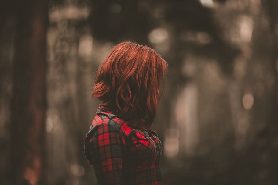 woman with short red hair wearing red and black plaid shirt, people