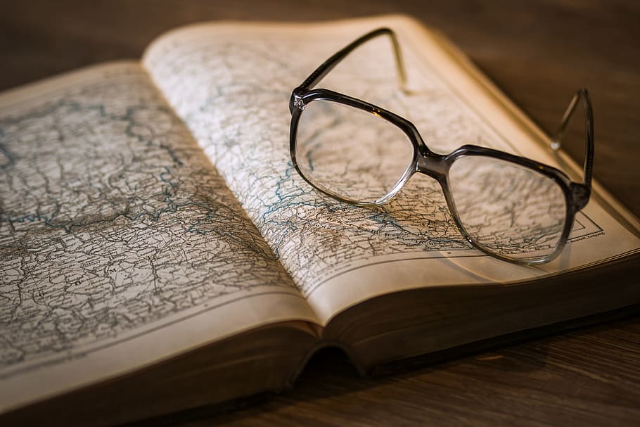 Map in open book and reading glasses, various, books, education