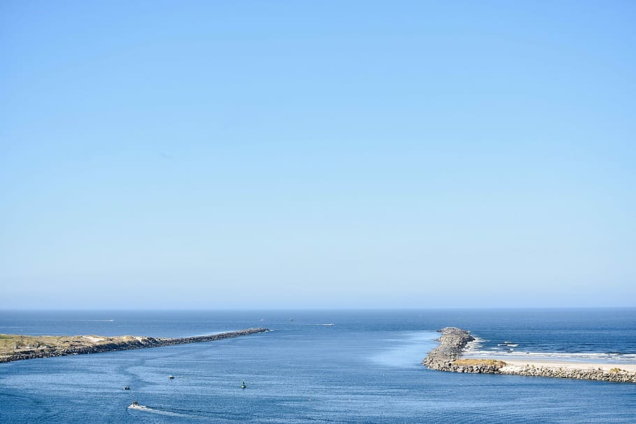 photo of coastline, body of water under blue sky during daytime photo HD wallpaper