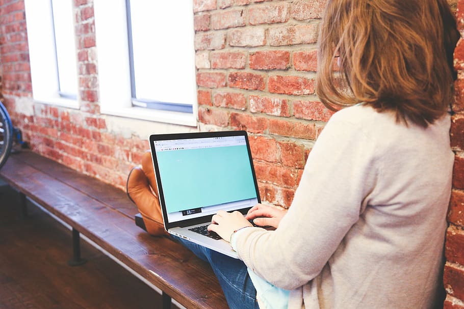 woman sitting while using laptop, holding, black, gray, computer HD wallpaper