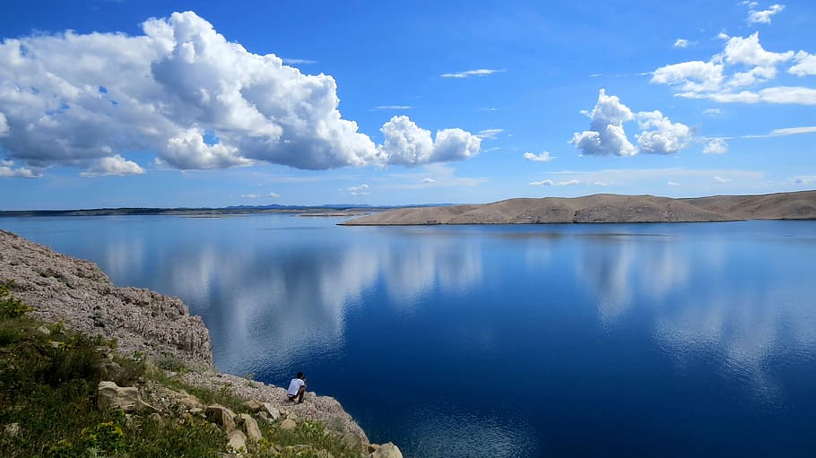 body of water between two gray rock moutains, clouds, reflection, HD wallpaper