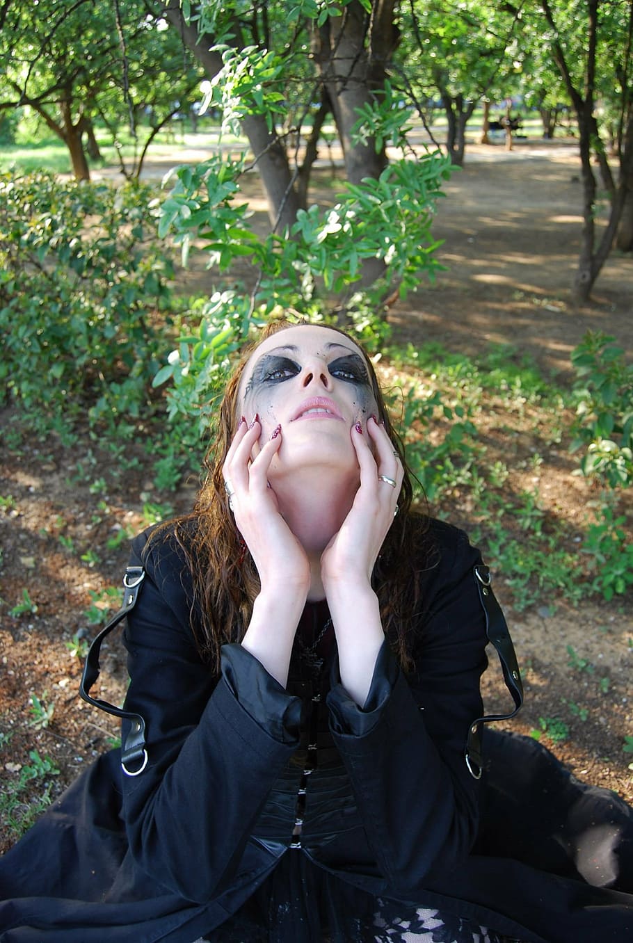 woman in black dress holding face with both hand, witch, forest HD wallpaper