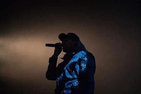 man holding microphone low light photography, man holding mic in front of his mouth HD wallpaper