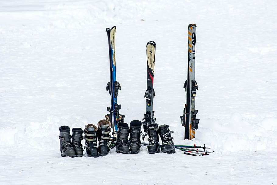 three snow skis, boots, and poles on snow, ski boots, equipment