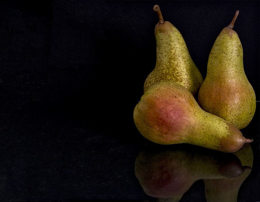 selective focus photography of three pears, three green pears in black background HD wallpaper