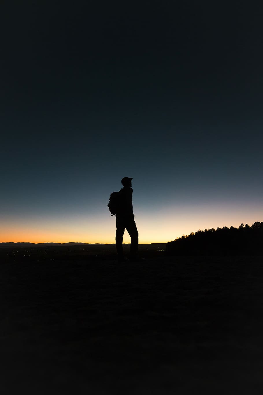 man with backpack in silhouette, silhouette of person carrying backpack standing near trees at golden hour HD wallpaper