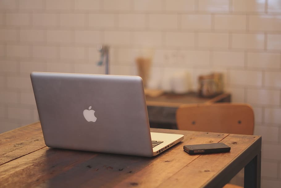 silver MacBook on brown table, notebook, home office, workstation HD wallpaper