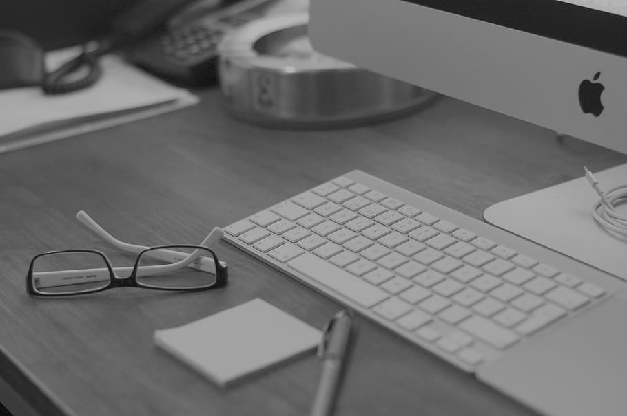 selective focus photography of black framed eyeglasses near white Apple magic keyboard HD wallpaper