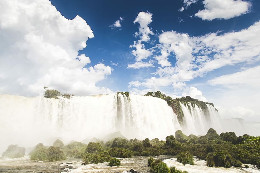 waterfalls raging through trees, green trees across waterfalls HD wallpaper