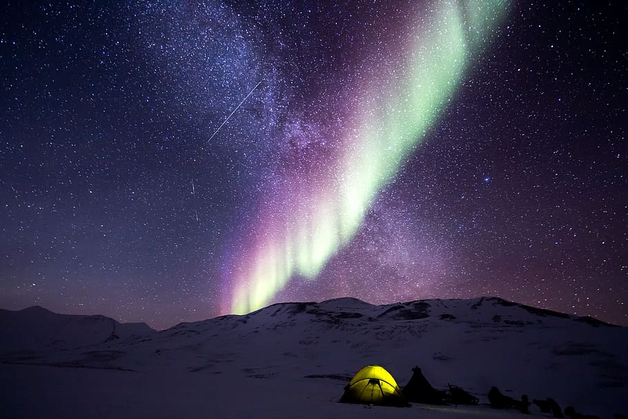 tents on snow covered terrain with purple aurora, night, north pole