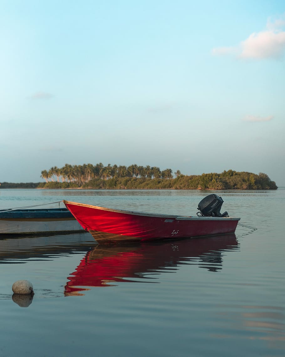 power boat parked in body of water, red motorboat on water near island HD wallpaper