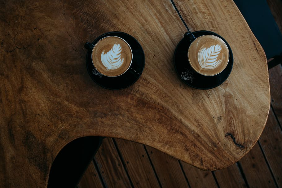two coffee arts on brown wooden table, two cappuccino on table HD wallpaper