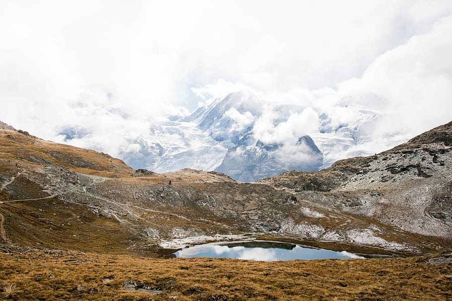 brown and gray mountain during daytime, mountain covered with clouds during daytime HD wallpaper