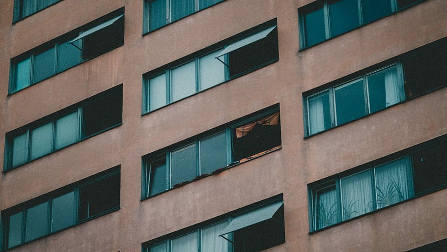 brown concrete building with glass windows, low angle photo of building HD wallpaper