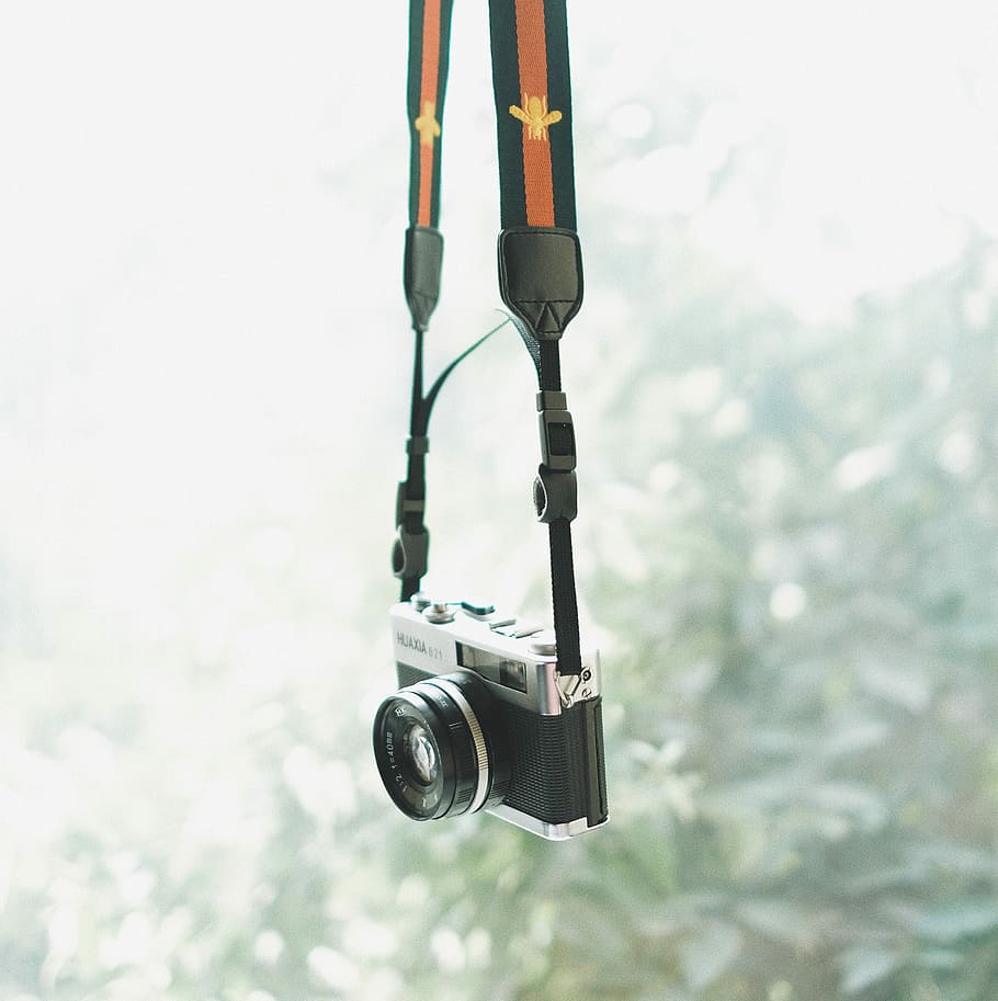 selective focus photography of hanging black and gray DSLR camera, camera hanging in the air