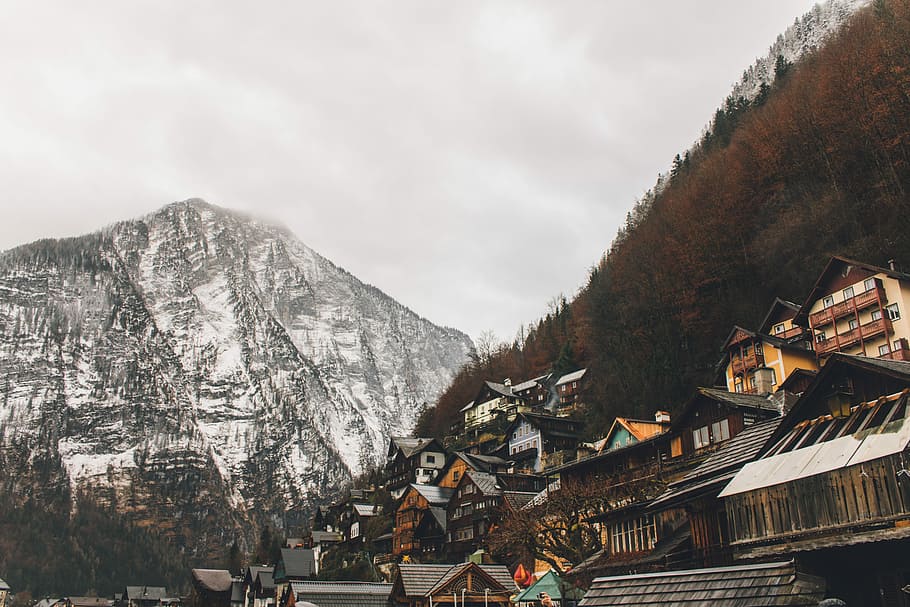 white and brown mountains near houses under gray sky during daytime, houses on mountain during daytime HD wallpaper