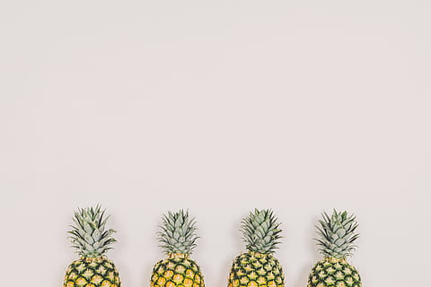 four pineapples on white background, four yellow pineapples near wall HD wallpaper