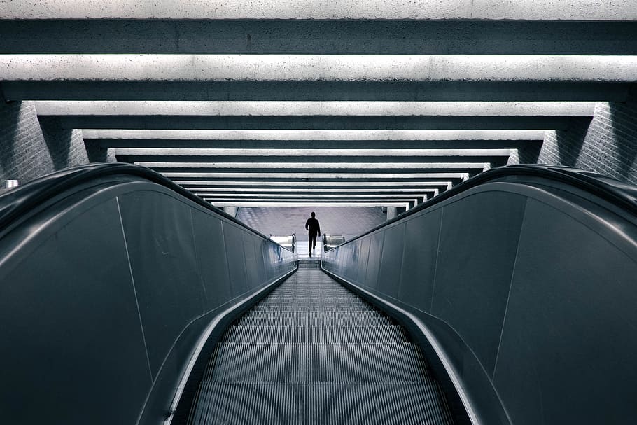 photo of person standing on escalator, down, building, stairs HD wallpaper