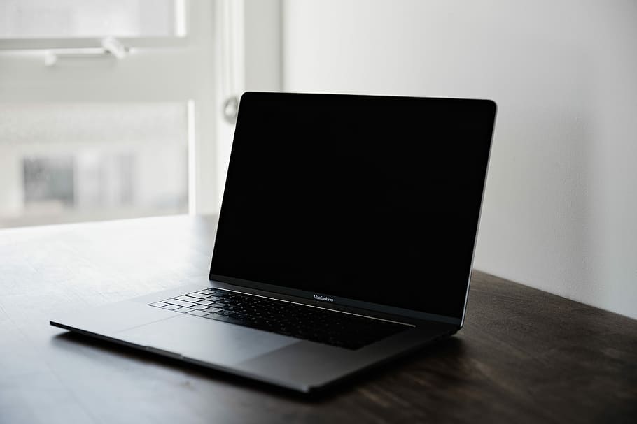 photo of black MacBook Pro on table, turned-off laptop computer HD wallpaper