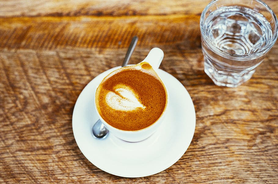 white mocha cup on white saucer plate beside drinking glass HD wallpaper