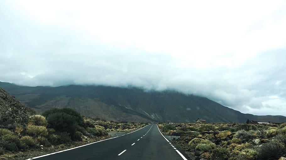 view of road and mountain covered by clouds, empty road leading to mountain covered in cumulus clouds HD wallpaper