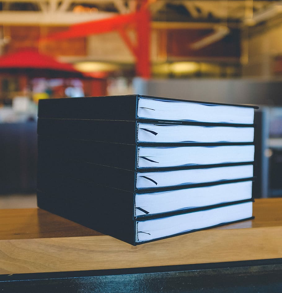 six black books on top of brown wooden table, black books on brown wooden surface HD wallpaper