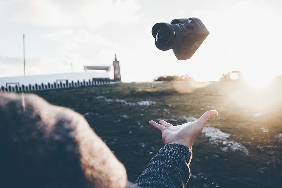 person's flipping back DSLR camera, person tossing DSLR camera HD wallpaper