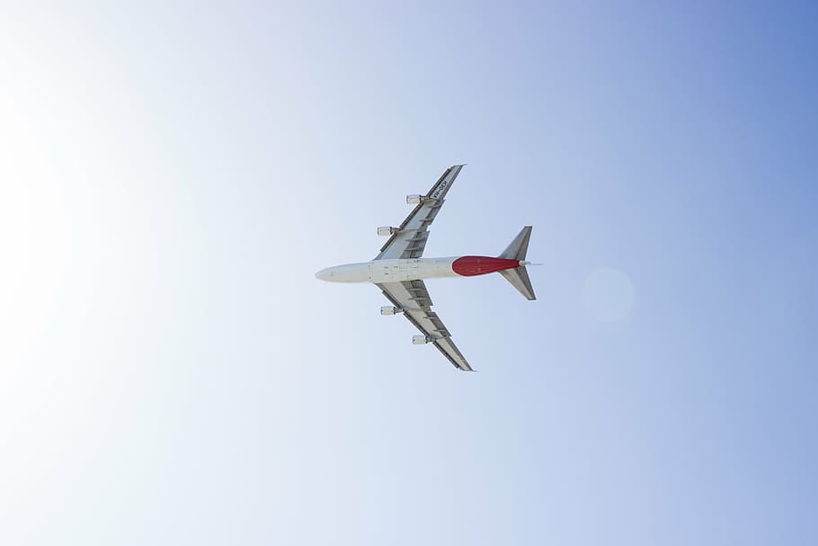 low-angle photography of white and red plane on mid-air under blue and white sky during daytime, HD wallpaper